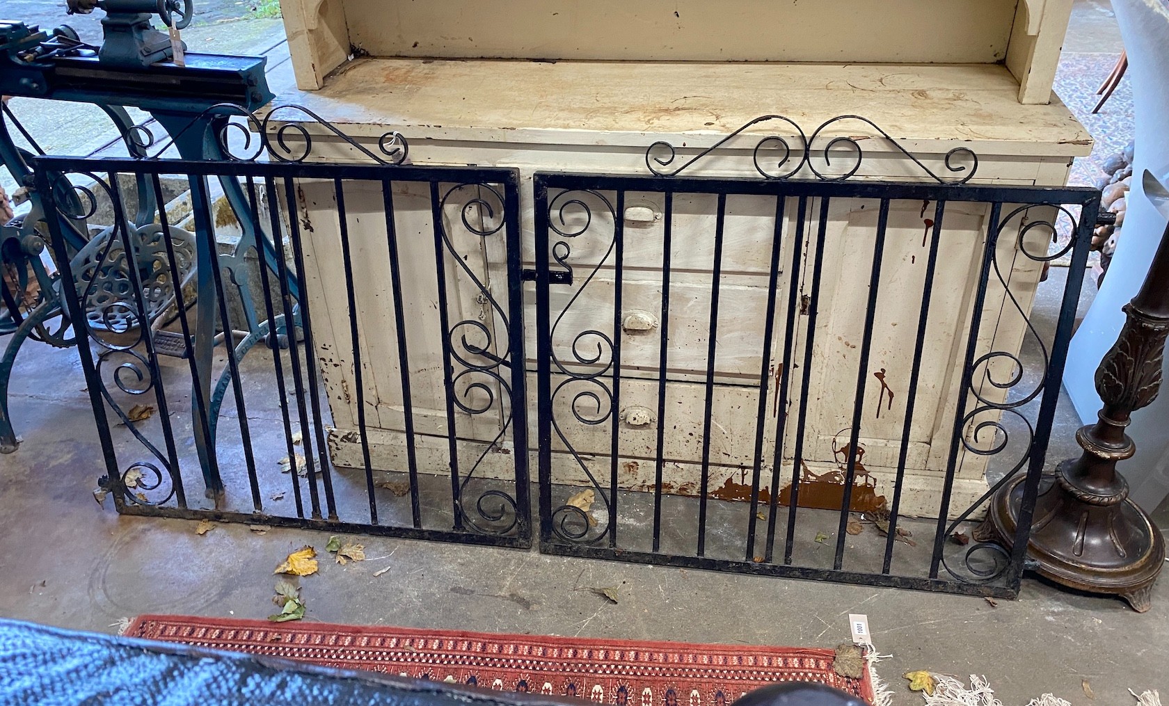 A pair of painted wrought iron garden gates, each gate width 101cm, height 99cm together with a Victorian cast iron campana urn section